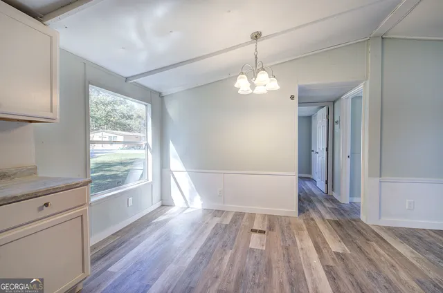 a kitchen with granite countertop white cabinets and a sink