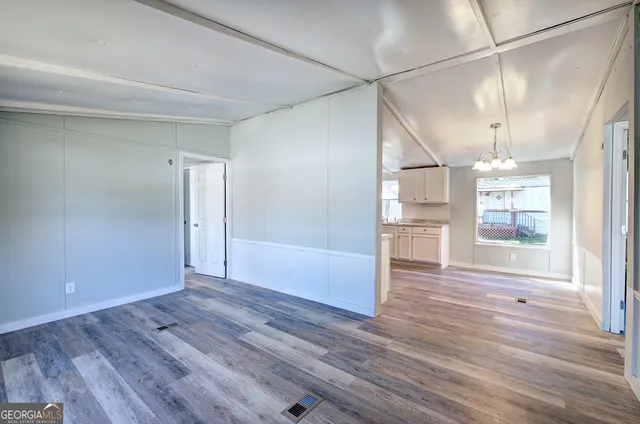 a kitchen with granite countertop a sink cabinets and stainless steel appliances