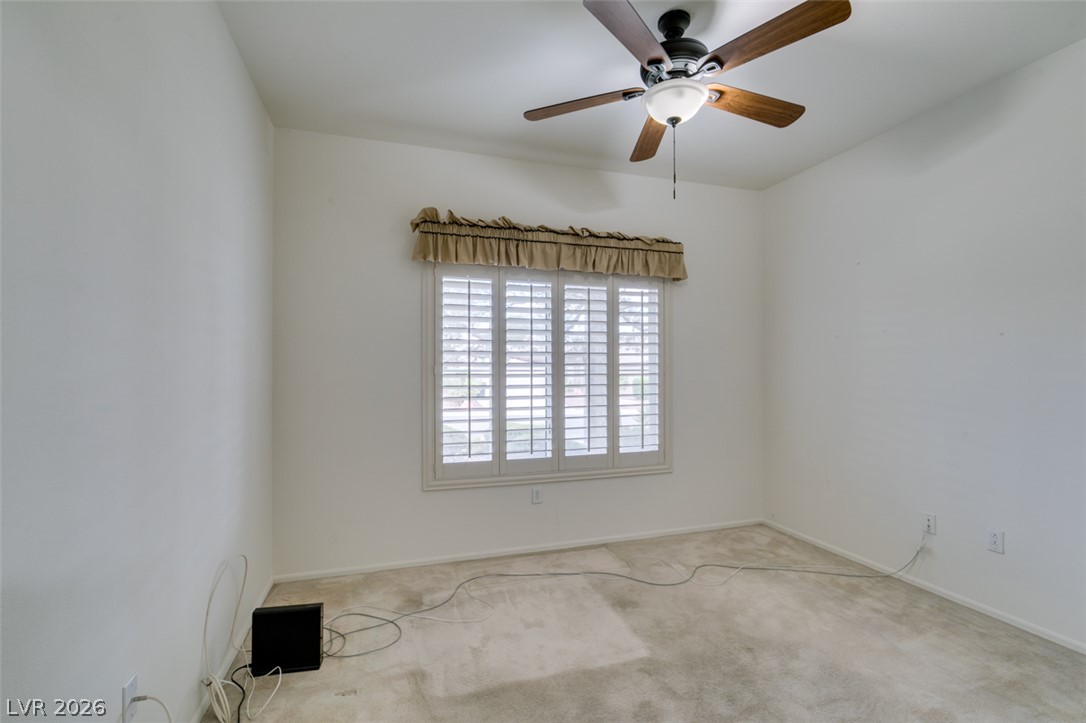 2189 Chapman Ranch Drive Henderson, NV 89012 - Photo 33 of 60 Natural light streams through plantation shutters into this versatile carpeted bedroom.