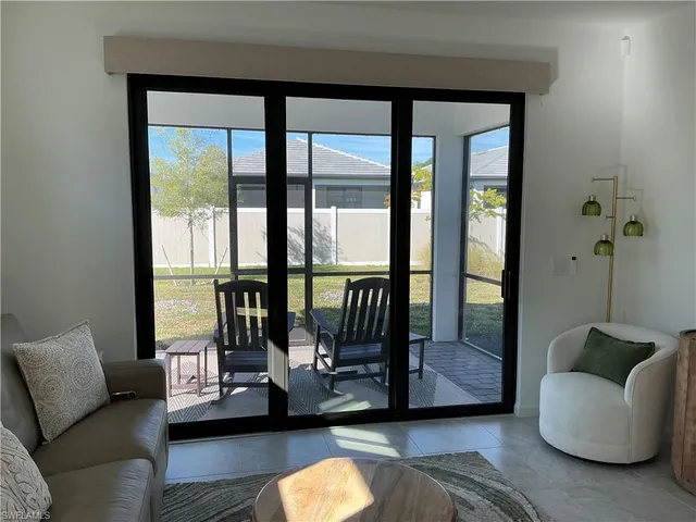 a living room with furniture and a painting on the wall