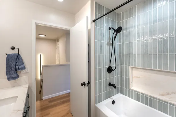 a bathroom with a tub a window and a shower