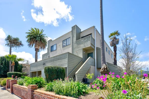 a front view of a house with lots of flower plants