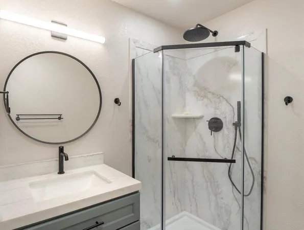 a bathroom with a shower and mirror