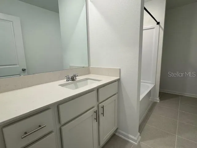 a bathroom with a sink double vanity and a mirror