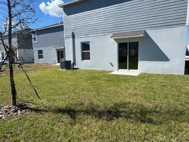 a view of a house with a backyard