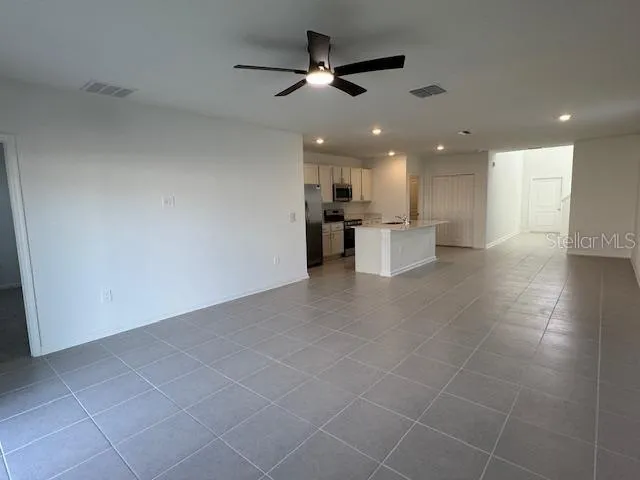 a view of a kitchen with a sink and microwave
