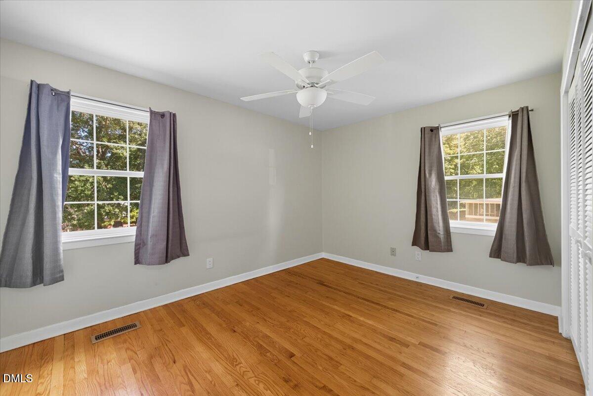 2604 Huntington Road Fayetteville, NC 28303 - Photo 24 of 48 a view of an empty room with wooden floor and a window
