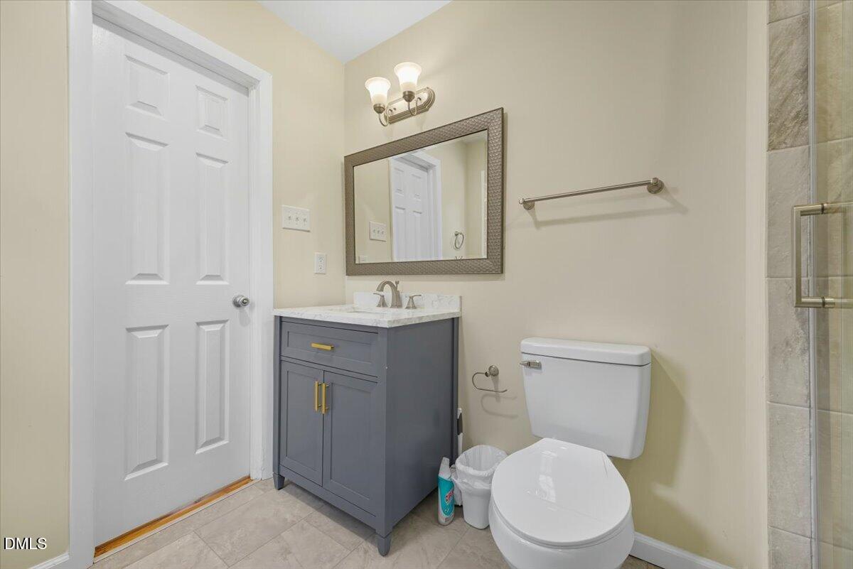 2604 Huntington Road Fayetteville, NC 28303 - Photo 26 of 48 a bathroom with a toilet a sink and mirror