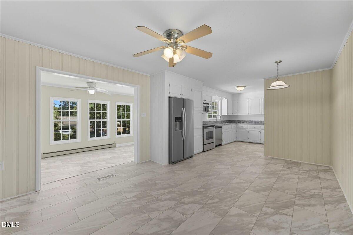 2604 Huntington Road Fayetteville, NC 28303 - Photo 6 of 48 a view of an empty room with window and cabinet