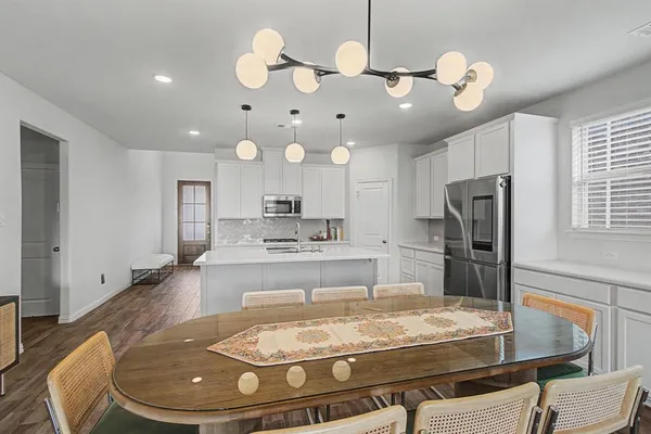 a kitchen with stainless steel appliances kitchen island granite countertop a stove and refrigerator