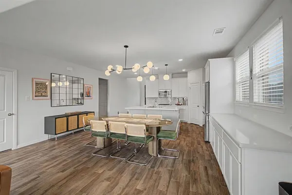 a view of a dining room with furniture and wooden floor