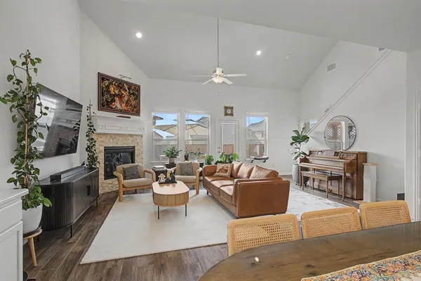 a living room with furniture fireplace and a large window