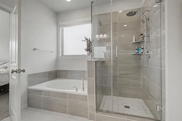 a bathroom with a bathtub and shower