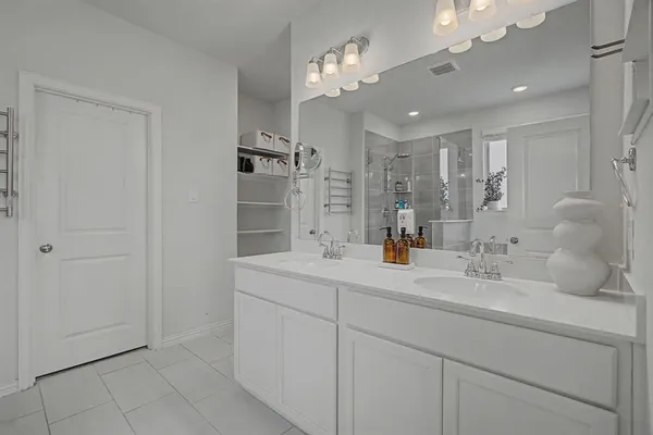 a bathroom with a sink double vanity and a mirror