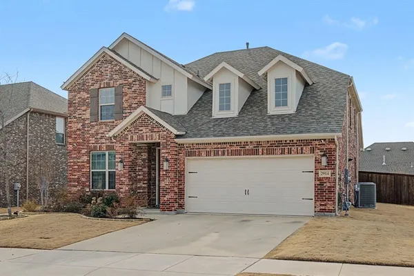 a front view of a house with garage