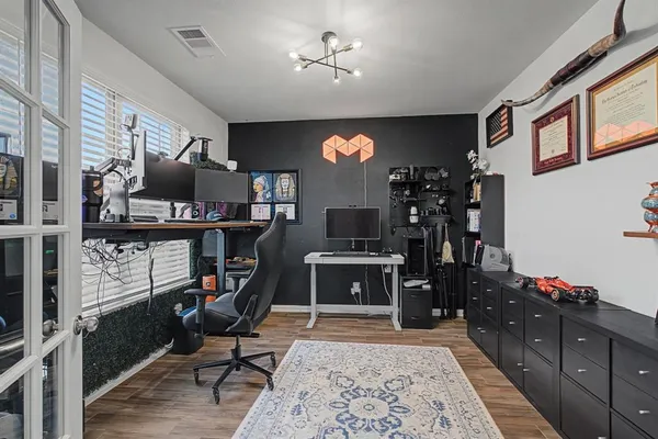 a view of a workspace with furniture and a kitchen