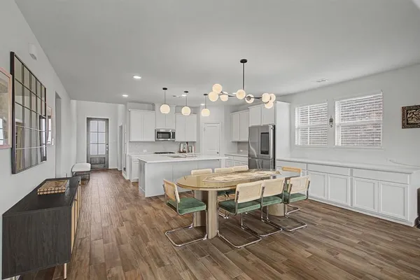 a view of a dining room with furniture window and wooden floor