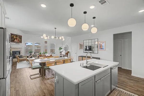 a kitchen that has a table chairs and wooden floor