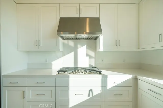 a kitchen with a stove and cabinets