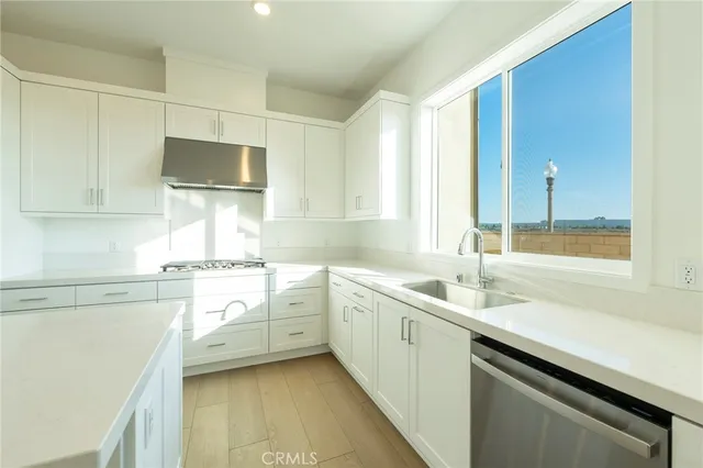 a kitchen with a sink a stove and cabinets