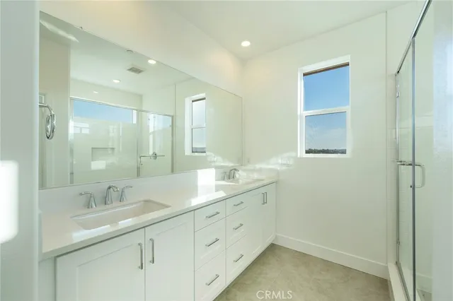 a bathroom with 2 sink tub and a mirror