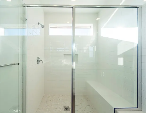 a bathroom with a glass shower door