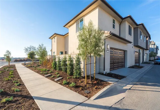 a front view of a house with trees