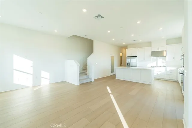 a view of a kitchen with a sink and a refrigerator