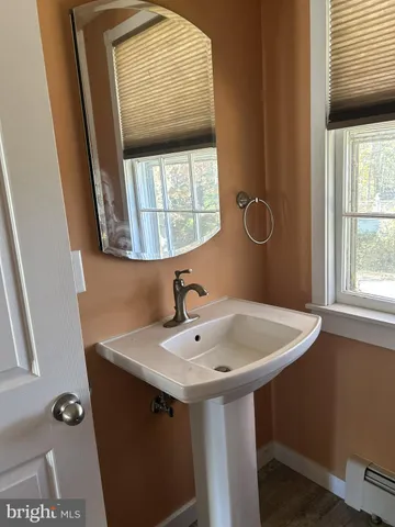 a bathroom with a sink and a window