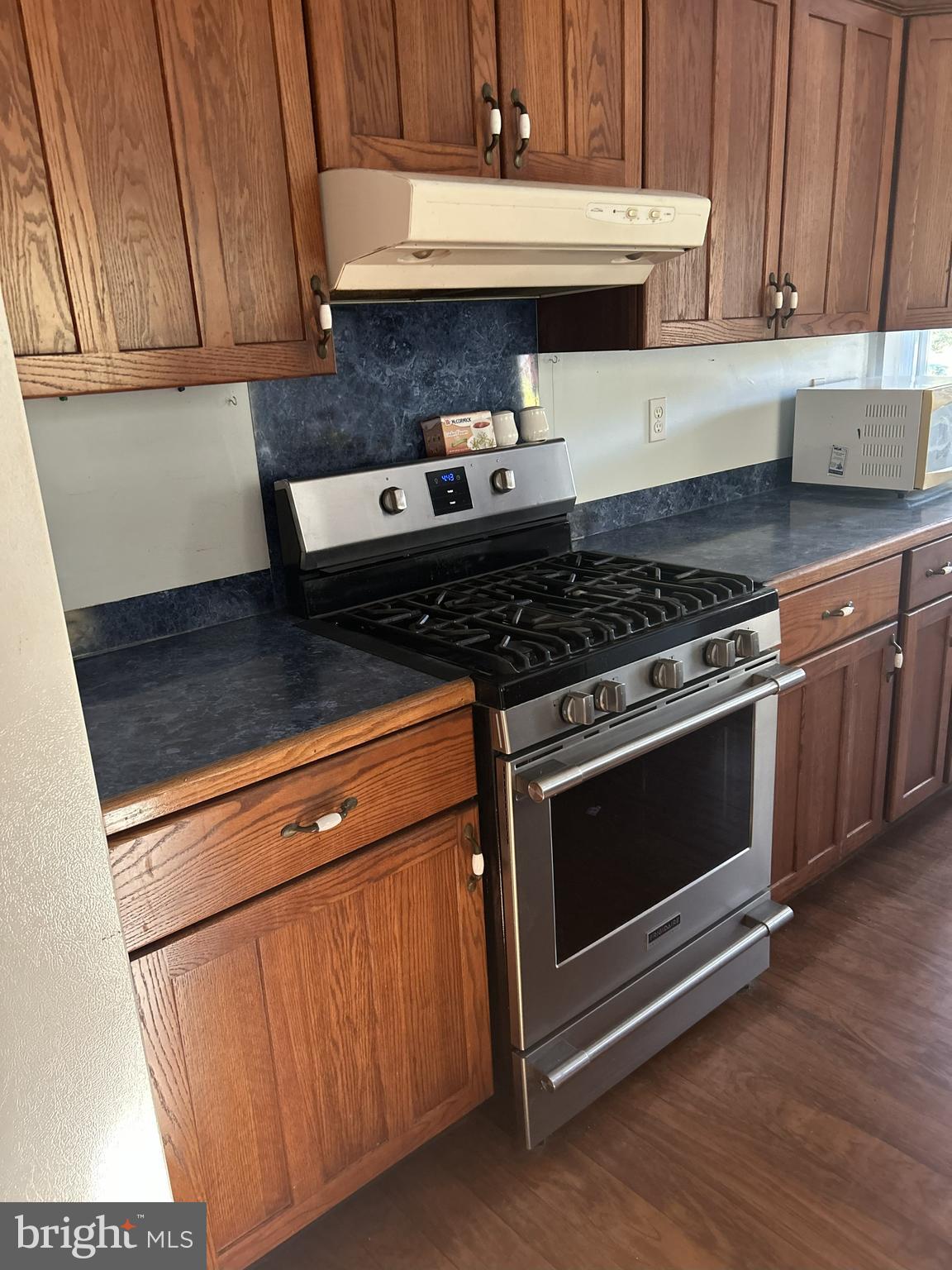 62 Rehill Avenue Elkton, MD 21921 - Photo 28 of 40 a kitchen with granite countertop a stove and a microwave