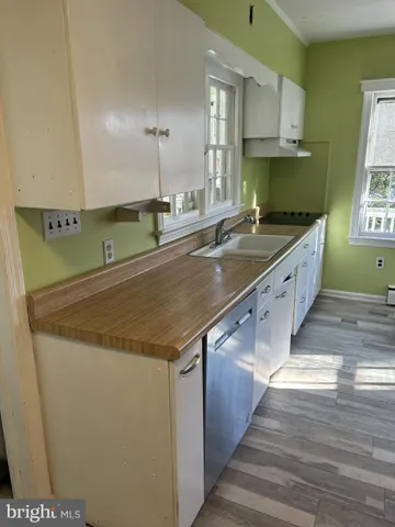 a large kitchen with stainless steel appliances granite countertop a sink and a stove