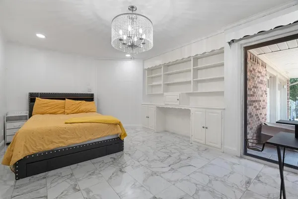 a bedroom with a bed and a chandelier