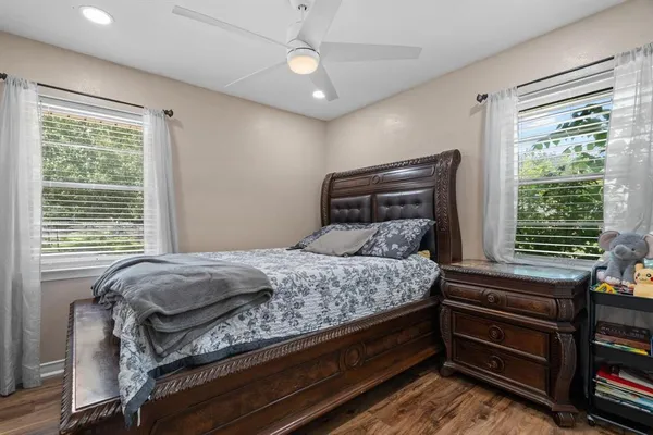 a bed sitting in a bedroom next to a window