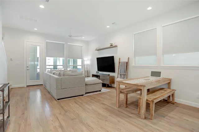 a living room with kitchen island furniture and a wooden floor