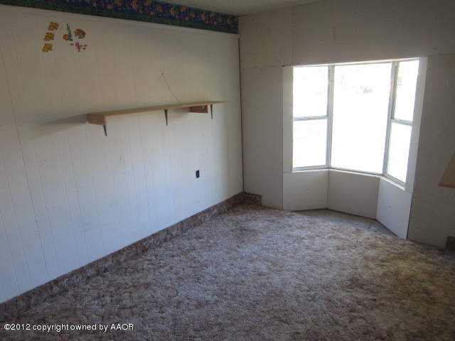 5122 South Bonham Street Amarillo, TX 79110 - Photo 8 of 15 a view of an empty room with a window