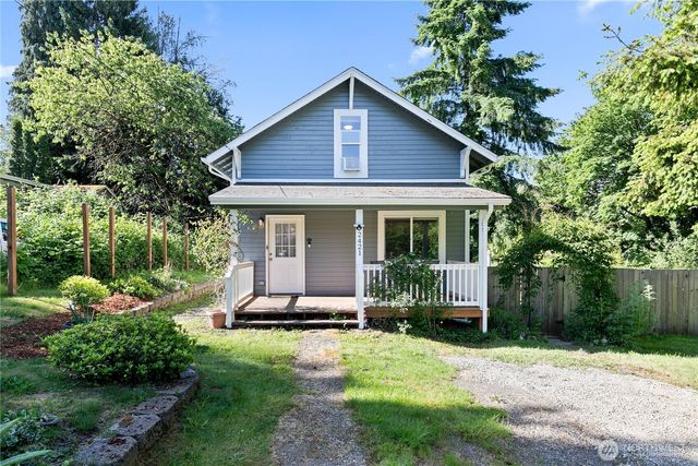a view of a house with backyard sitting area and garden