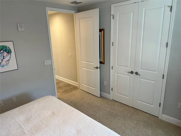 a front view of a house with a yard and palm trees