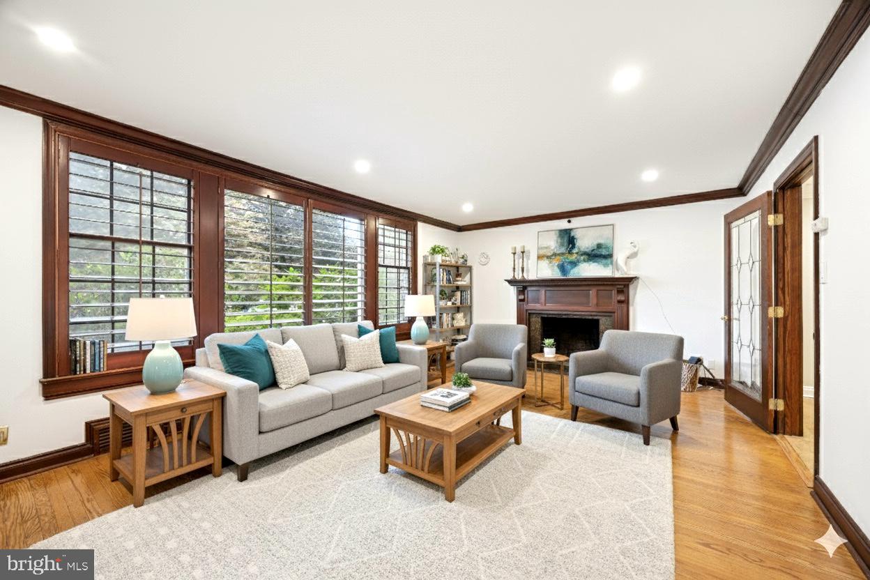 1726 Riverview Road Gladwyne, PA 19035 - Photo 11 of 38 a living room with furniture a large window and a fireplace