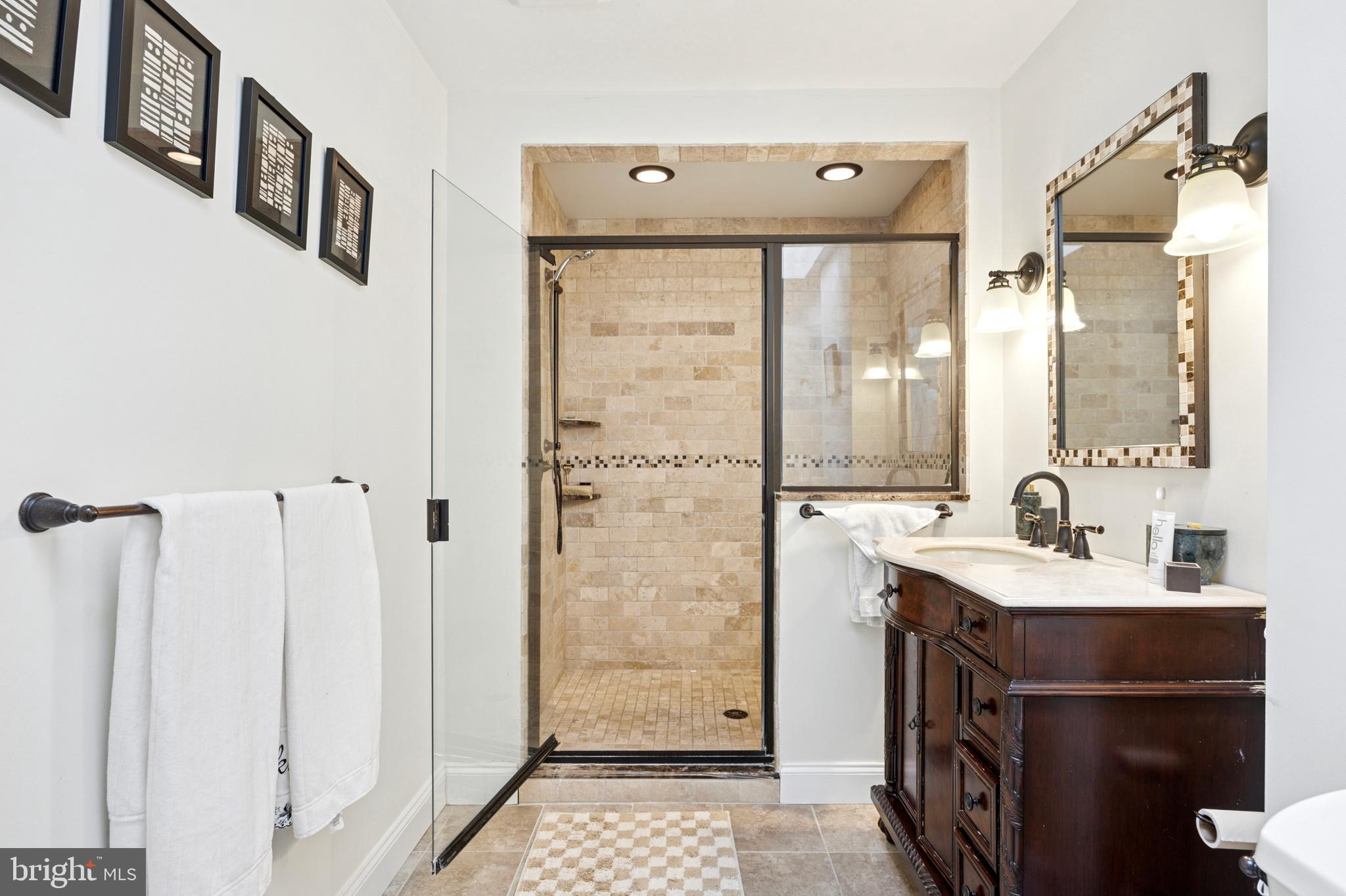 1726 Riverview Road Gladwyne, PA 19035 - Photo 15 of 38 a bathroom with a double vanity sink a mirror and a shower