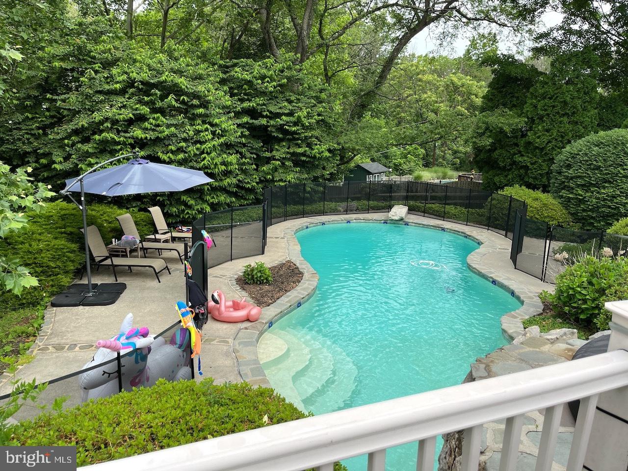 1726 Riverview Road Gladwyne, PA 19035 - Photo 34 of 38 a view of a swimming pool with a patio and a garden