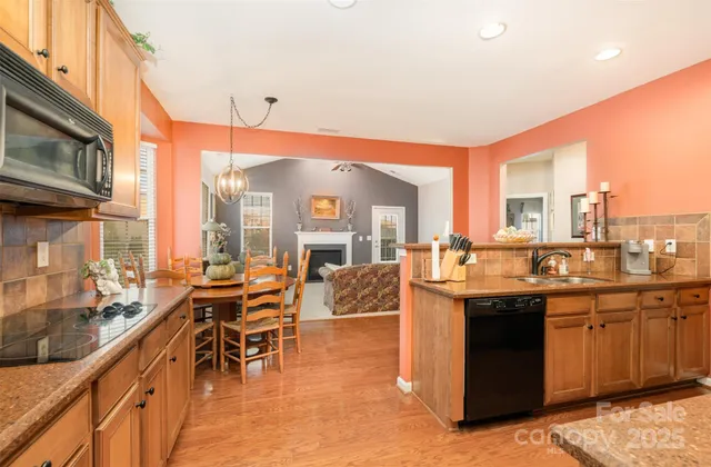 a kitchen with stainless steel appliances granite countertop a stove and cabinets