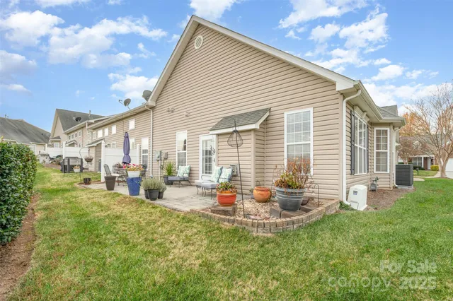 a backyard of a house with table and chairs