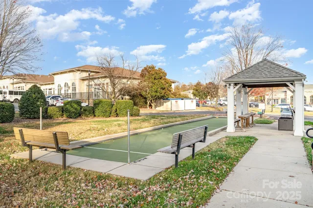 a view of a white house with a street