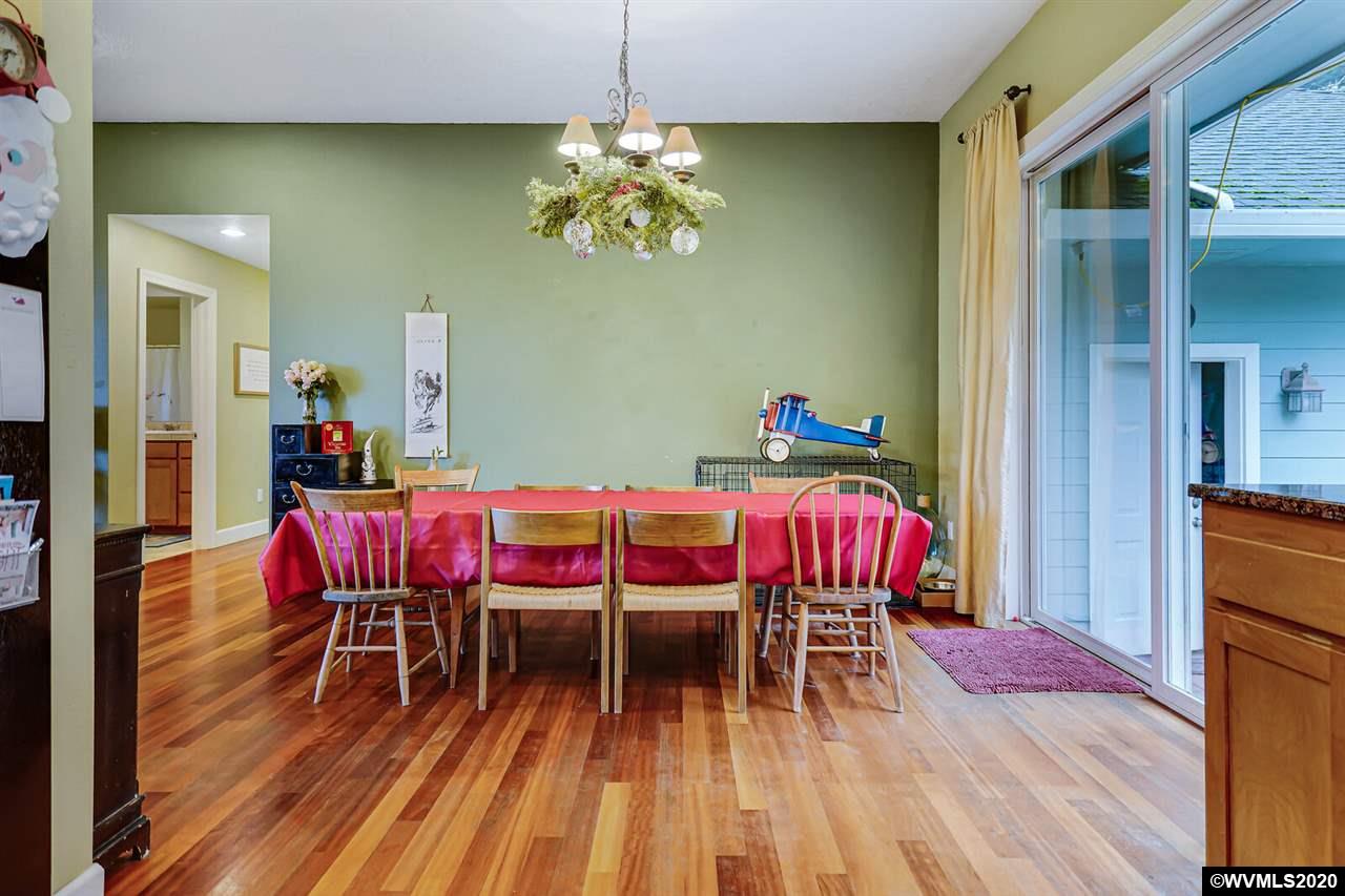 2065 Southeast Godsey Road Dallas, OR 97338 - Photo 19 of 34 a dining room with furniture a chandelier and wooden floor