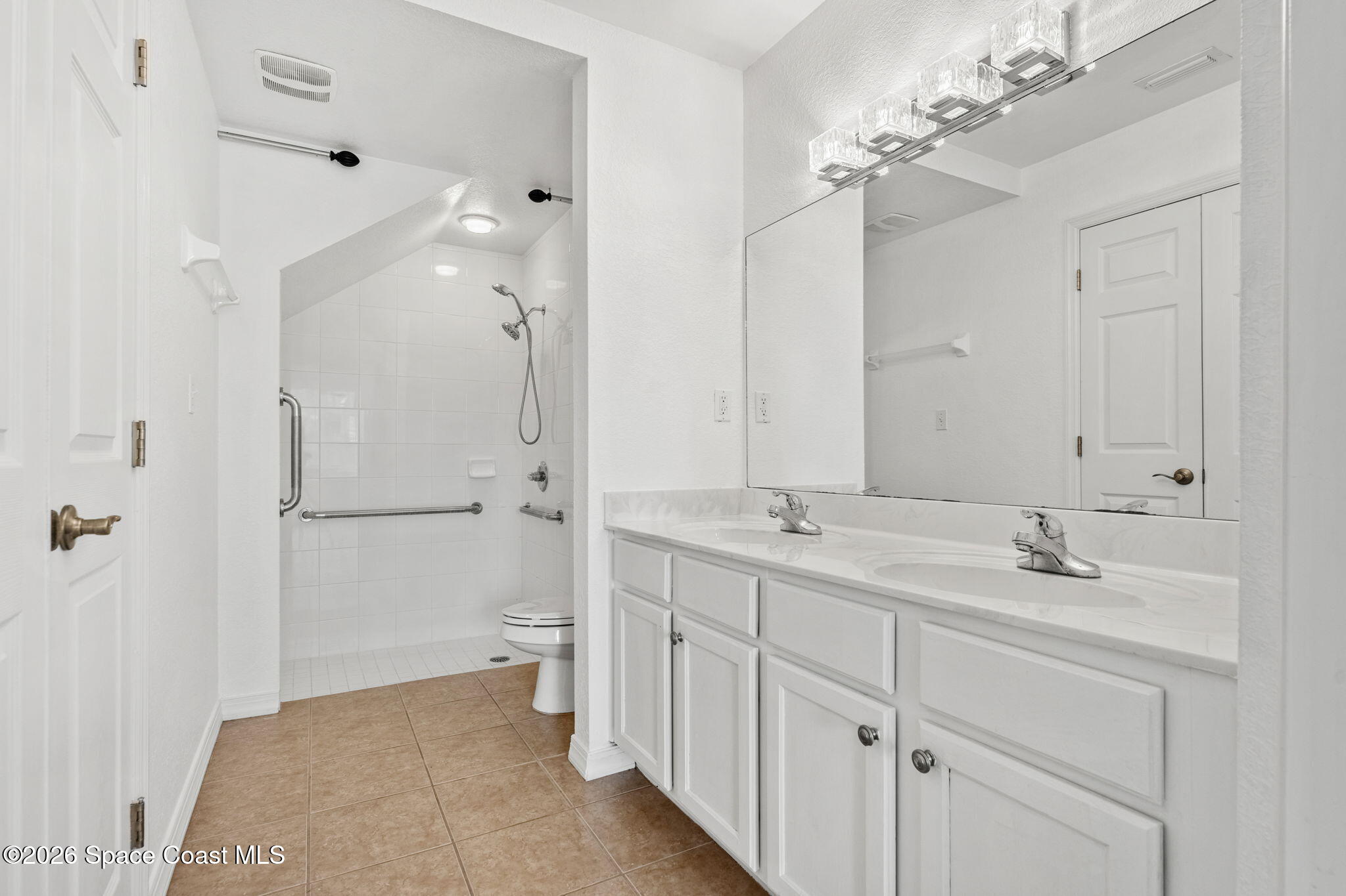 110 Turpial Way, Unit 106 Melbourne, FL 32901 - Photo 25 of 50 a spacious bathroom with a double vanity sink mirror and shower