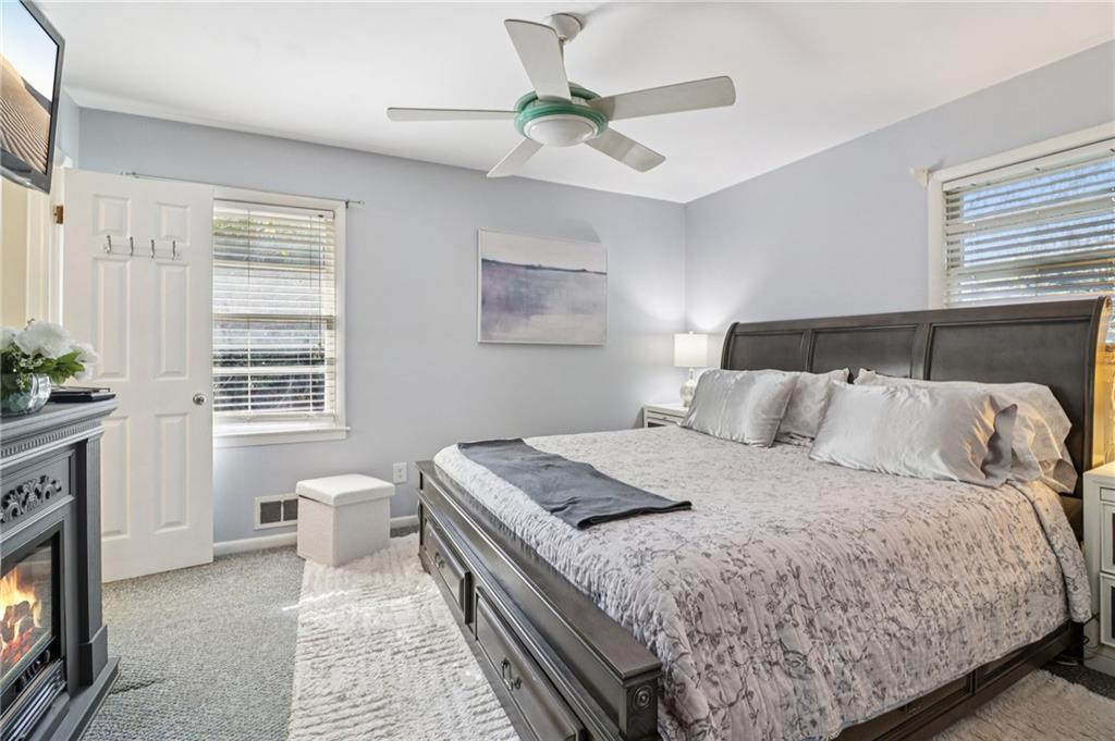 957 Texel Lane Clarkston, GA 30021 - Photo 11 of 27 a bedroom with a bed and a ceiling fan