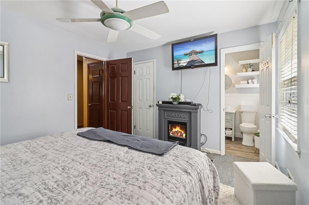 957 Texel Lane Clarkston, GA 30021 - Photo 12 of 27 a bedroom with a bed and a fireplace