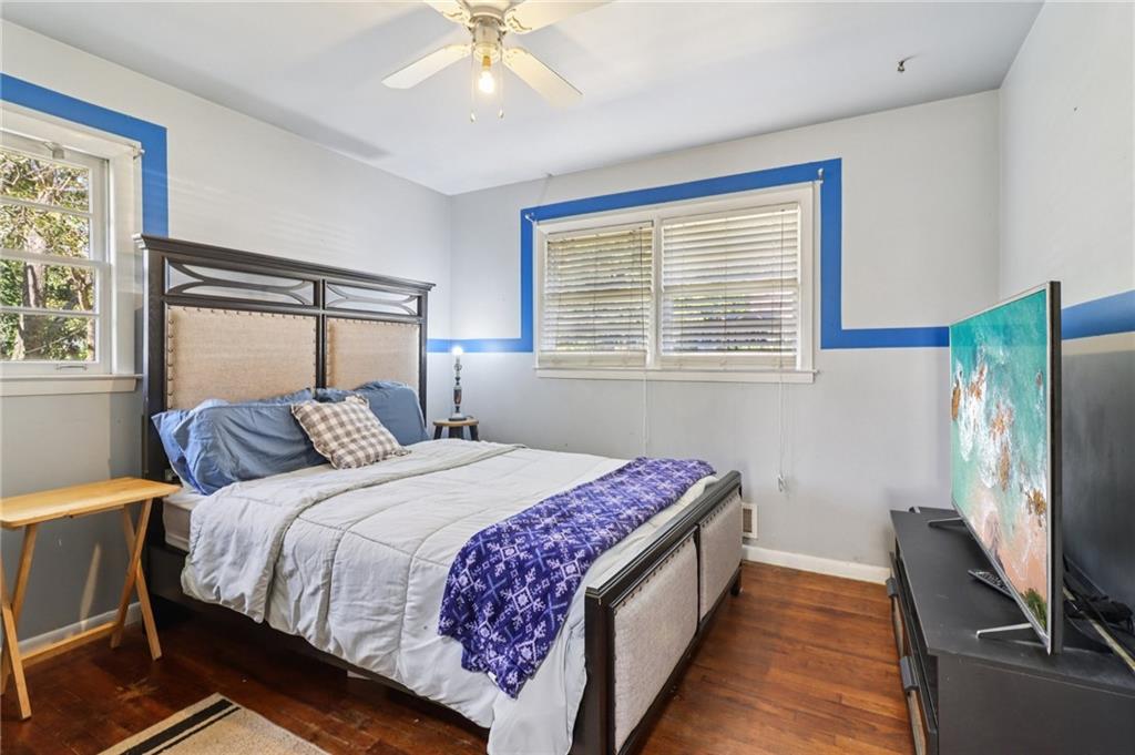 957 Texel Lane Clarkston, GA 30021 - Photo 15 of 27 a bedroom with a bed and a flat tv screen on dresser