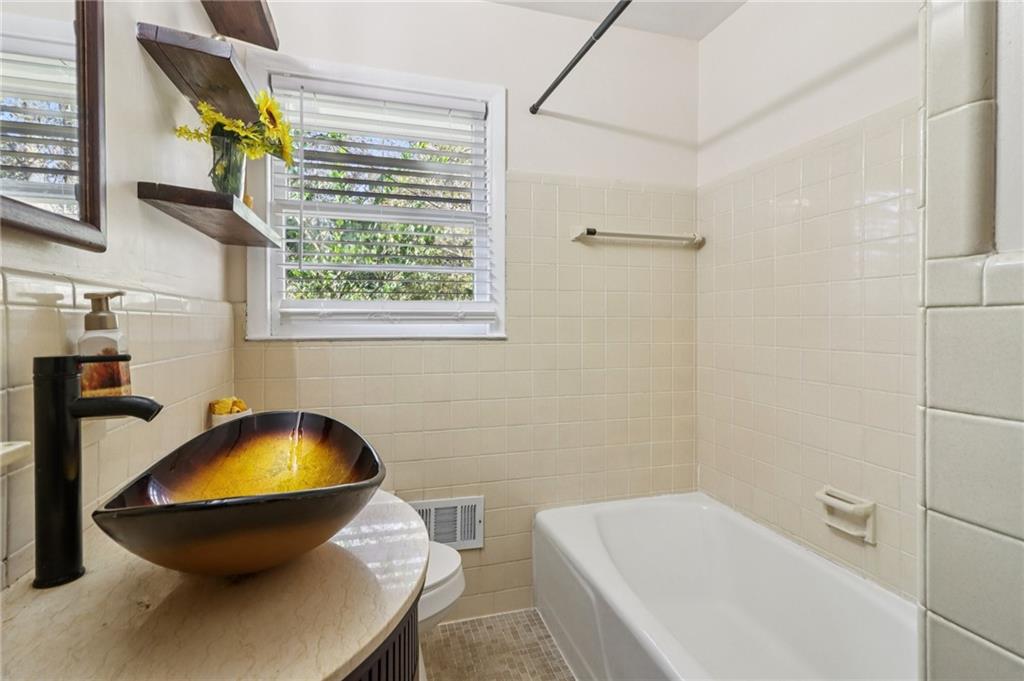 957 Texel Lane Clarkston, GA 30021 - Photo 16 of 27 a bathroom with a sink and a tub