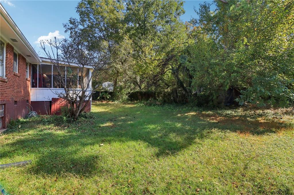957 Texel Lane Clarkston, GA 30021 - Photo 17 of 27 a backyard of a house with table and chairs